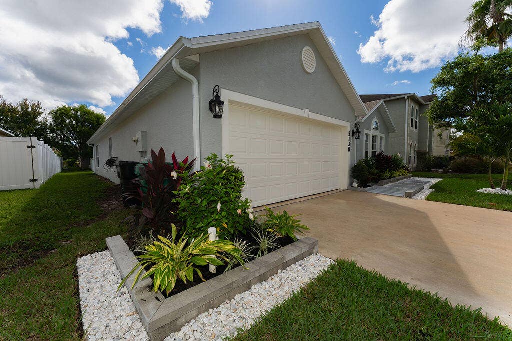 5138 NW WISK FERN Circle, Port St Lucie, FL 34986 Lush landscaping and stone work