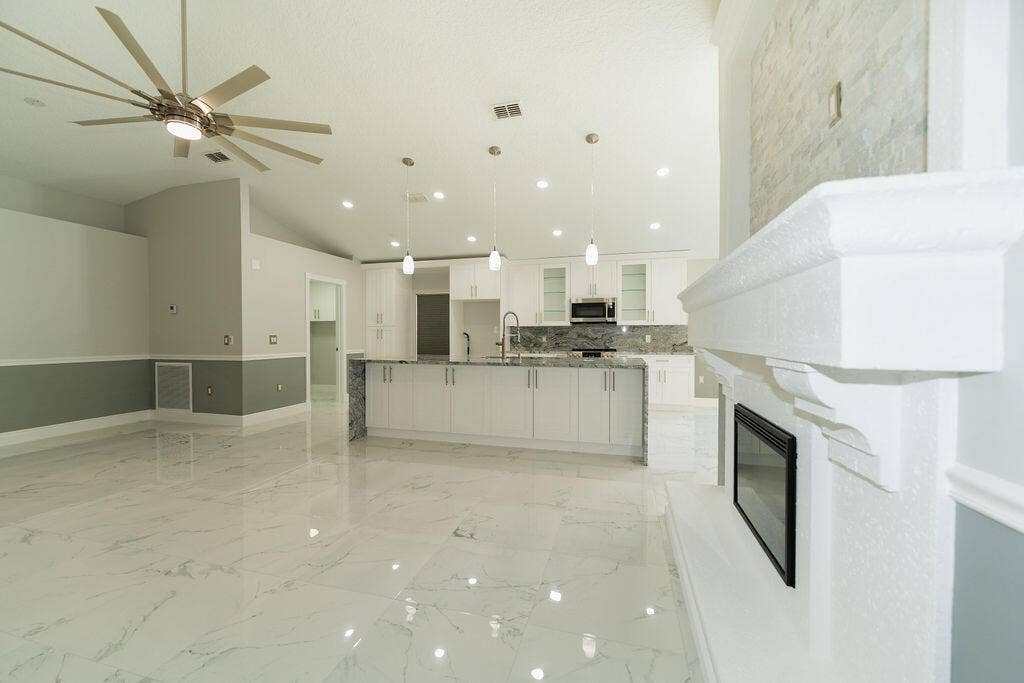 5138 NW WISK FERN Circle, Port St Lucie, FL 34986 Functional electrical fire place to help create a nice ambiance. Custom stone work around the fire place up to the ceilings with outlet set up for TV mount.
