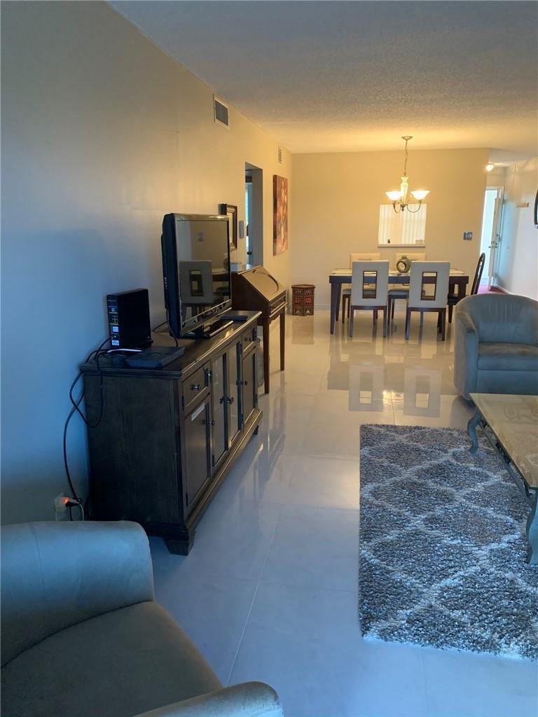 2305 LUCAYA Lane, #L4, Coconut Creek, Coconut Creek, FL 33066 Interior space featuring uniform polished tile flooring and a multi-arm, central light fixture
