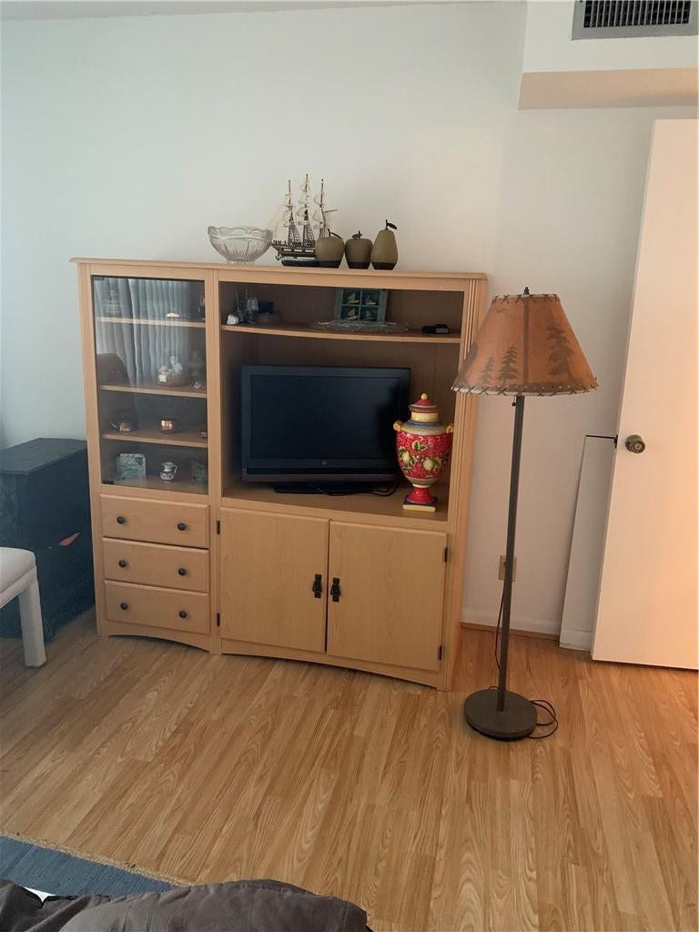 2305 LUCAYA Lane, #L4, Coconut Creek, Coconut Creek, FL 33066 Light-toned wood-finish flooring complemented by a built-in light wood cabinetry unit featuring glass-front display shelving and integrated storage drawers