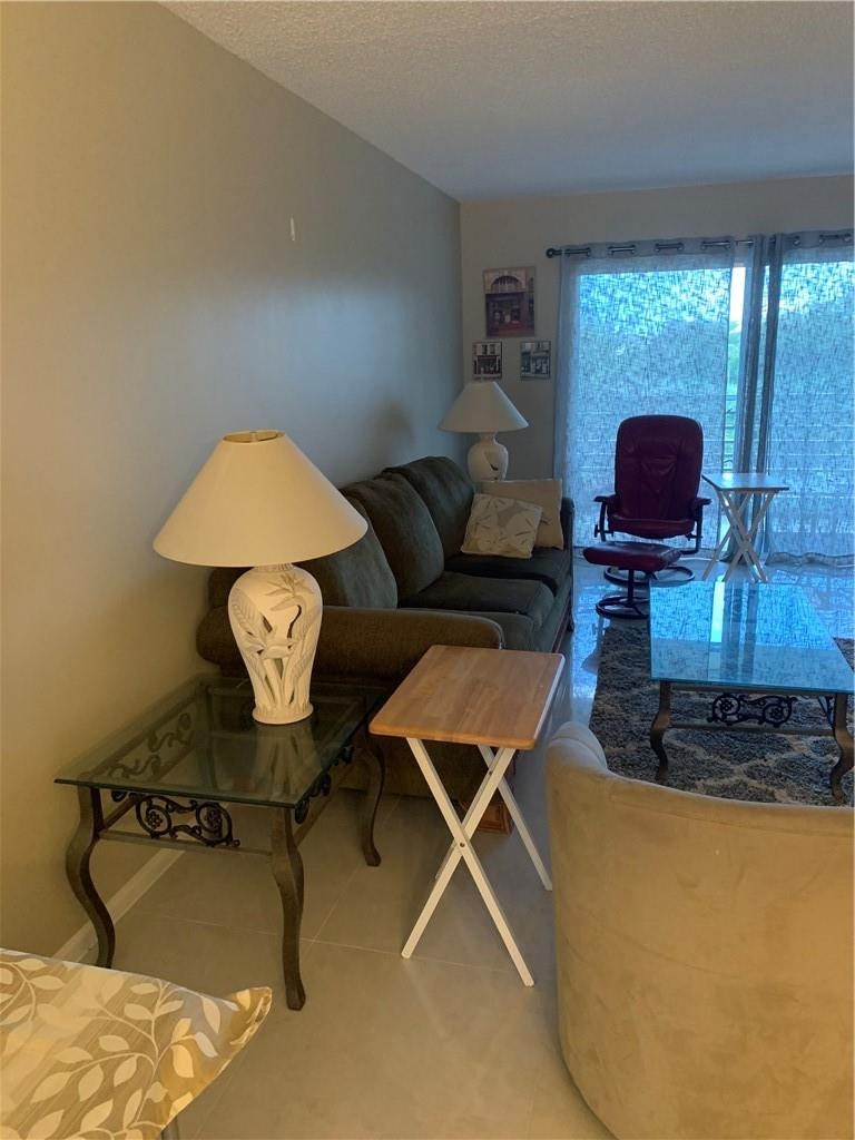 2305 LUCAYA Lane, #L4, Coconut Creek, Coconut Creek, FL 33066 Neutral-toned interior featuring large-format tile flooring and sliding glass doors
