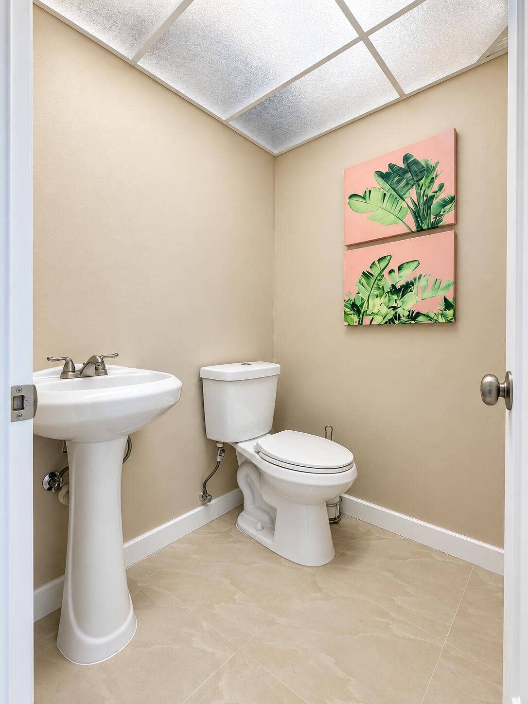 686 BRITTANY O, Delray Beach, FL 33446 Pedestal sink with two-handle faucet, white ceramic toilet, tile flooring, and drop ceiling with integrated lighting