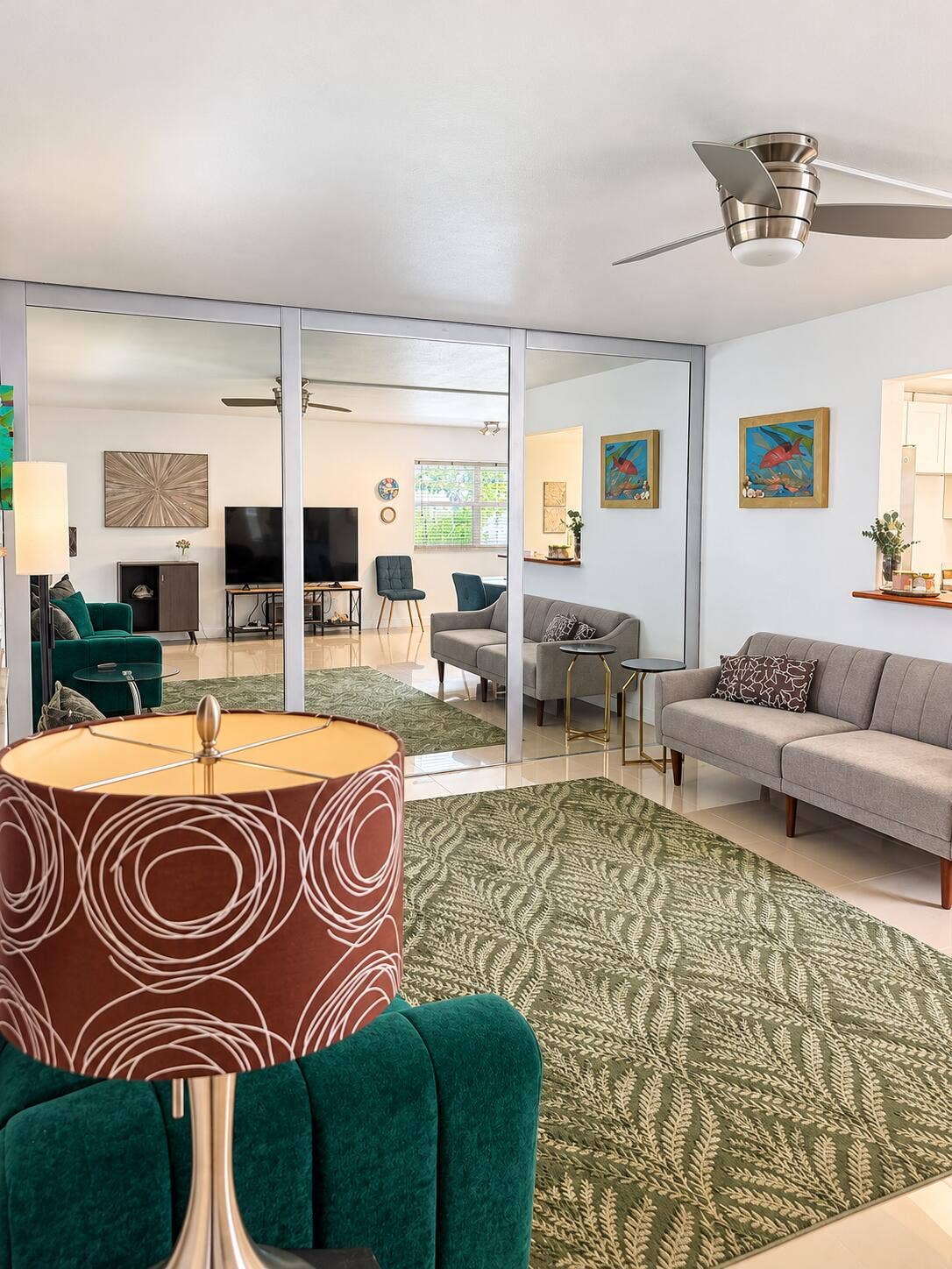 686 BRITTANY O, Delray Beach, FL 33446 Floor-to-ceiling mirrored wall panels, polished tile flooring, brushed-nickel ceiling fan with integrated lighting, and a pass-through window with a wood-finish ledge
