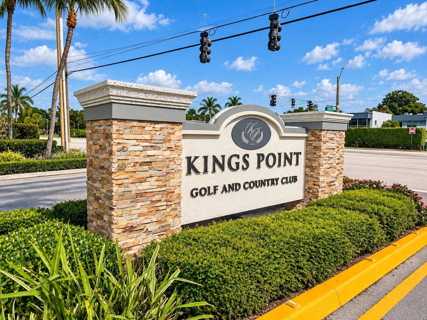 686 BRITTANY O, Delray Beach, FL 33446 Kings Point Golf and Country Club entrance signage featuring stacked stone masonry columns, molded concrete caps, and professional landscaping