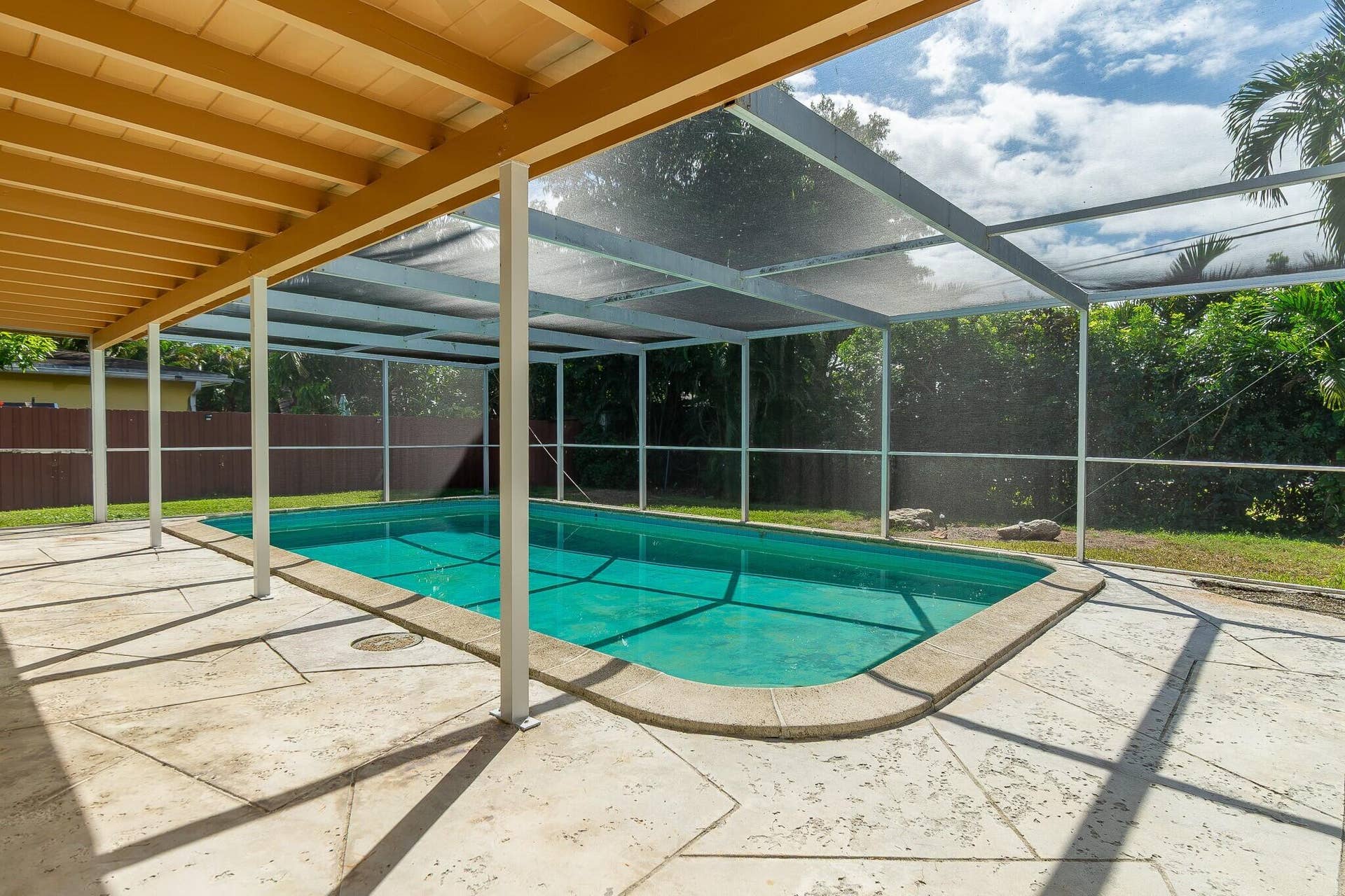 Enclosed pool with covered patio area