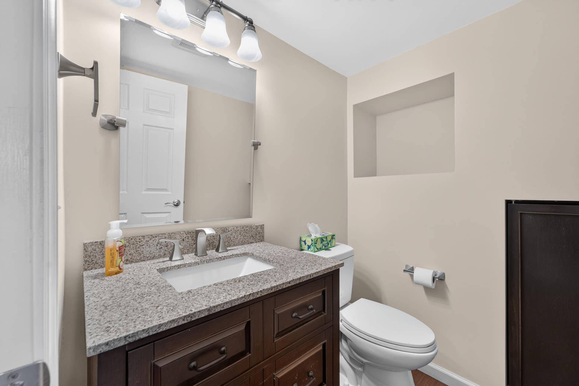 Downstairs Half Bath, storage under stairs