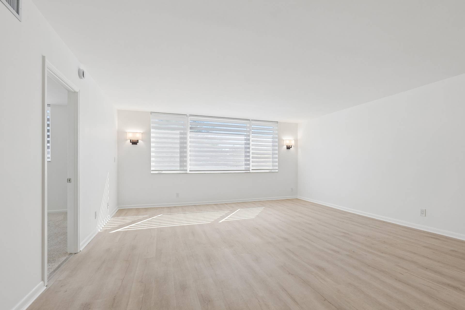 711 N Birch Road, #204, Fort Lauderdale, FL 33304 Bright light from the East with Hunter Douglas shades. Classy sconce lighting on wall.