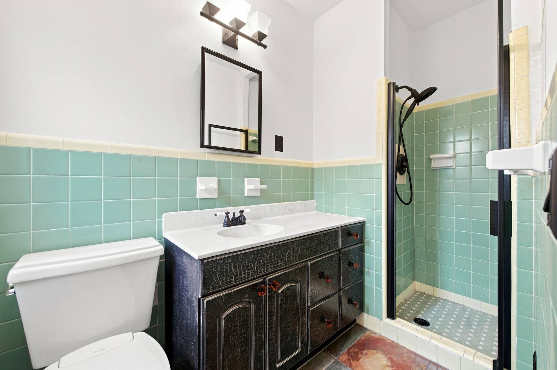1110 SW 18TH Court, Fort Lauderdale, FL 33315 Bathroom featuring a vanity with a white countertop and oval under-mount sink, matte black hardware, a tiled shower enclosure, and a rectangular wall mirror