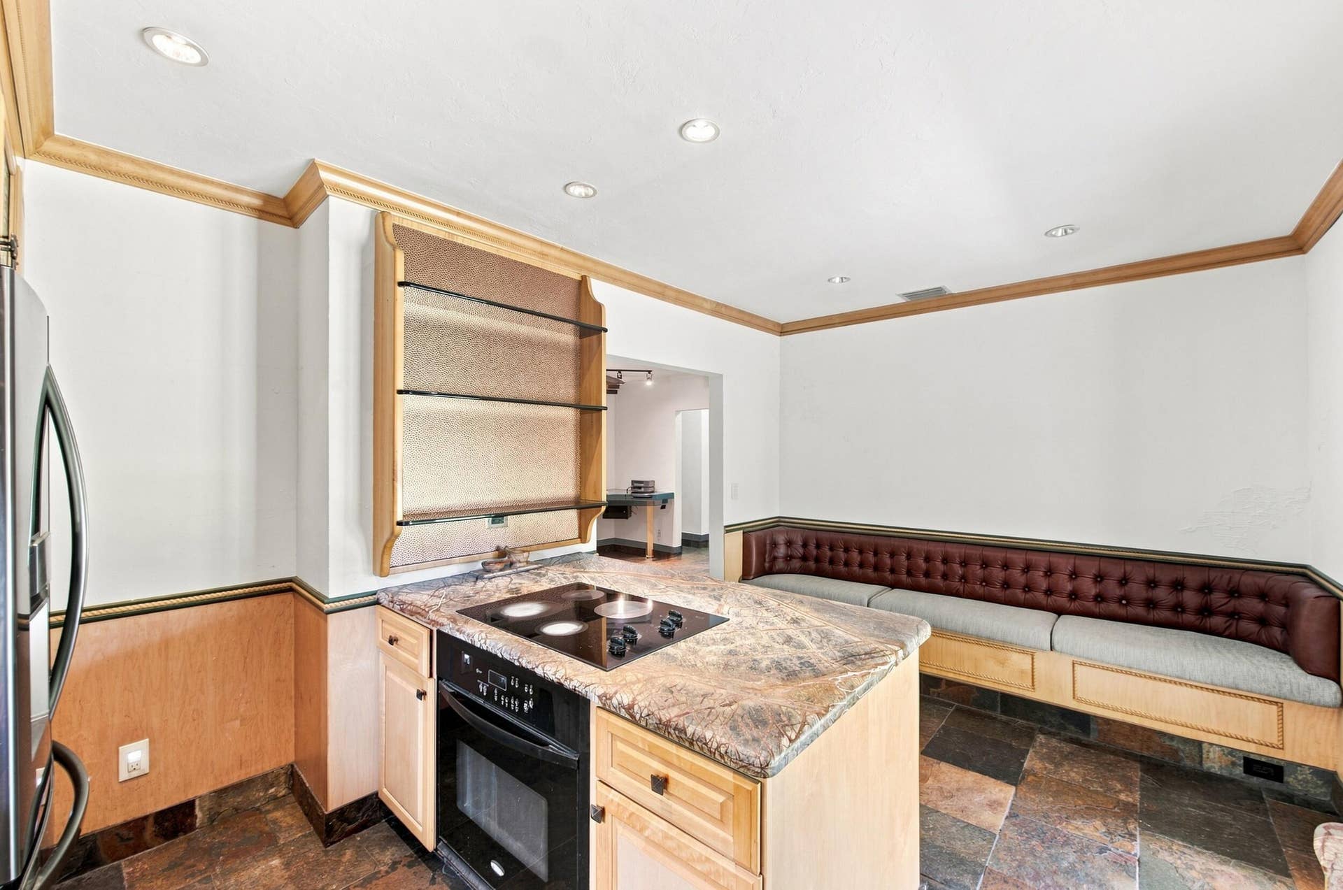 1110 SW 18TH Court, Fort Lauderdale, FL 33315 Galley kitchen featuring stainless steel appliances, wood-finish cabinetry, and patterned stone countertops