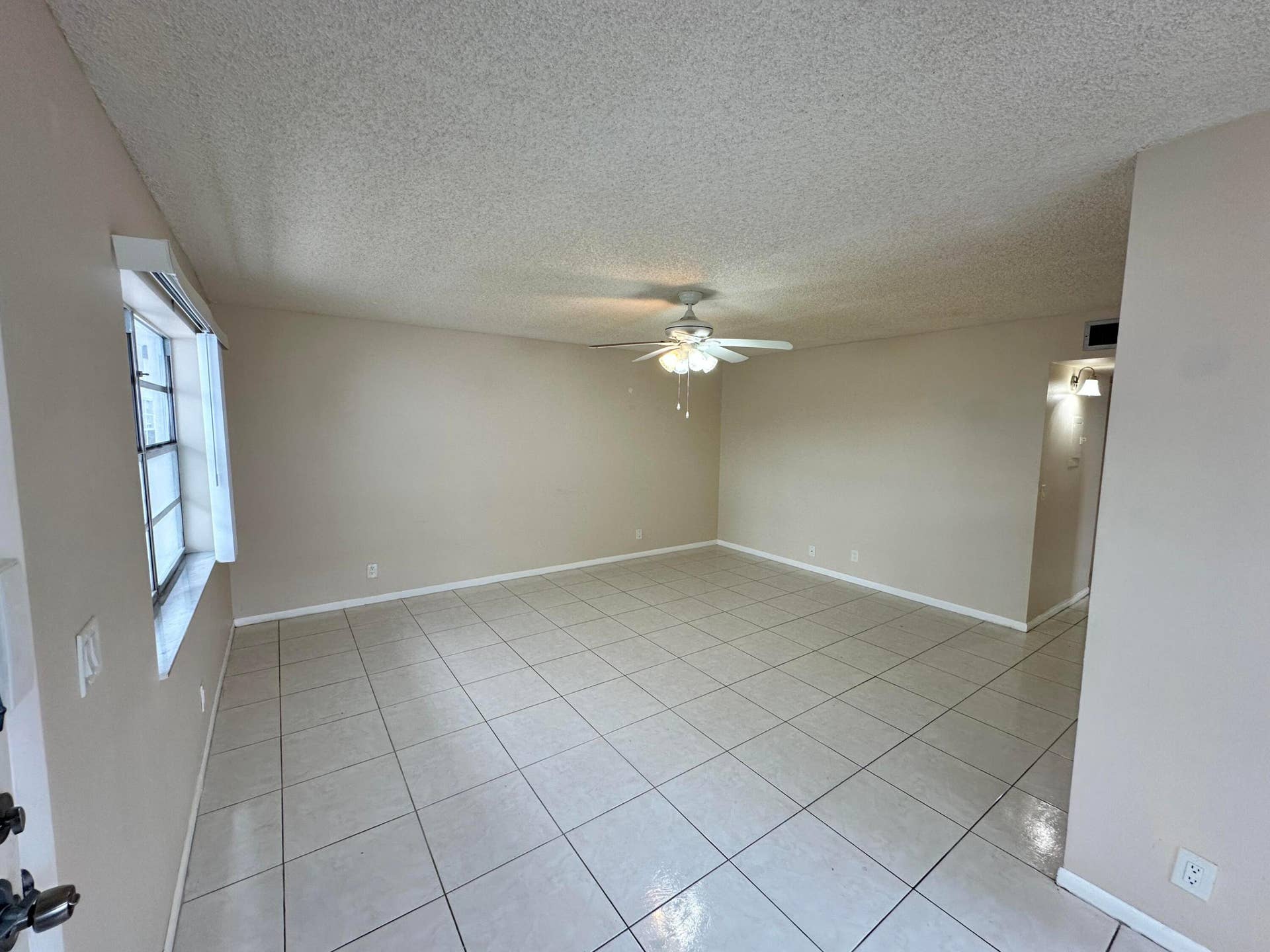 Spacious Living and Dining Area with Kitchen to the Left