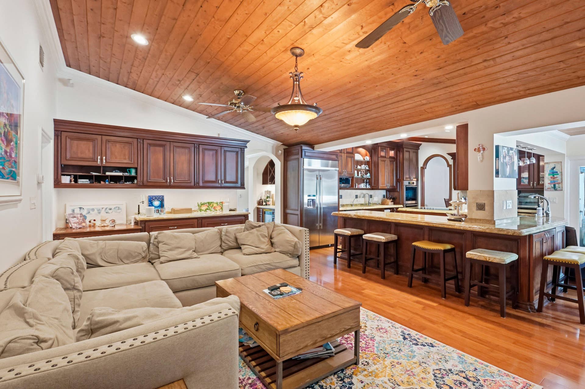 2919 Banyan Blvd Circle NW, Boca Raton, FL 33431 Vaulted wood-plank ceiling featuring recessed lighting, custom wood cabinetry, stone countertops, and wood-finish flooring
