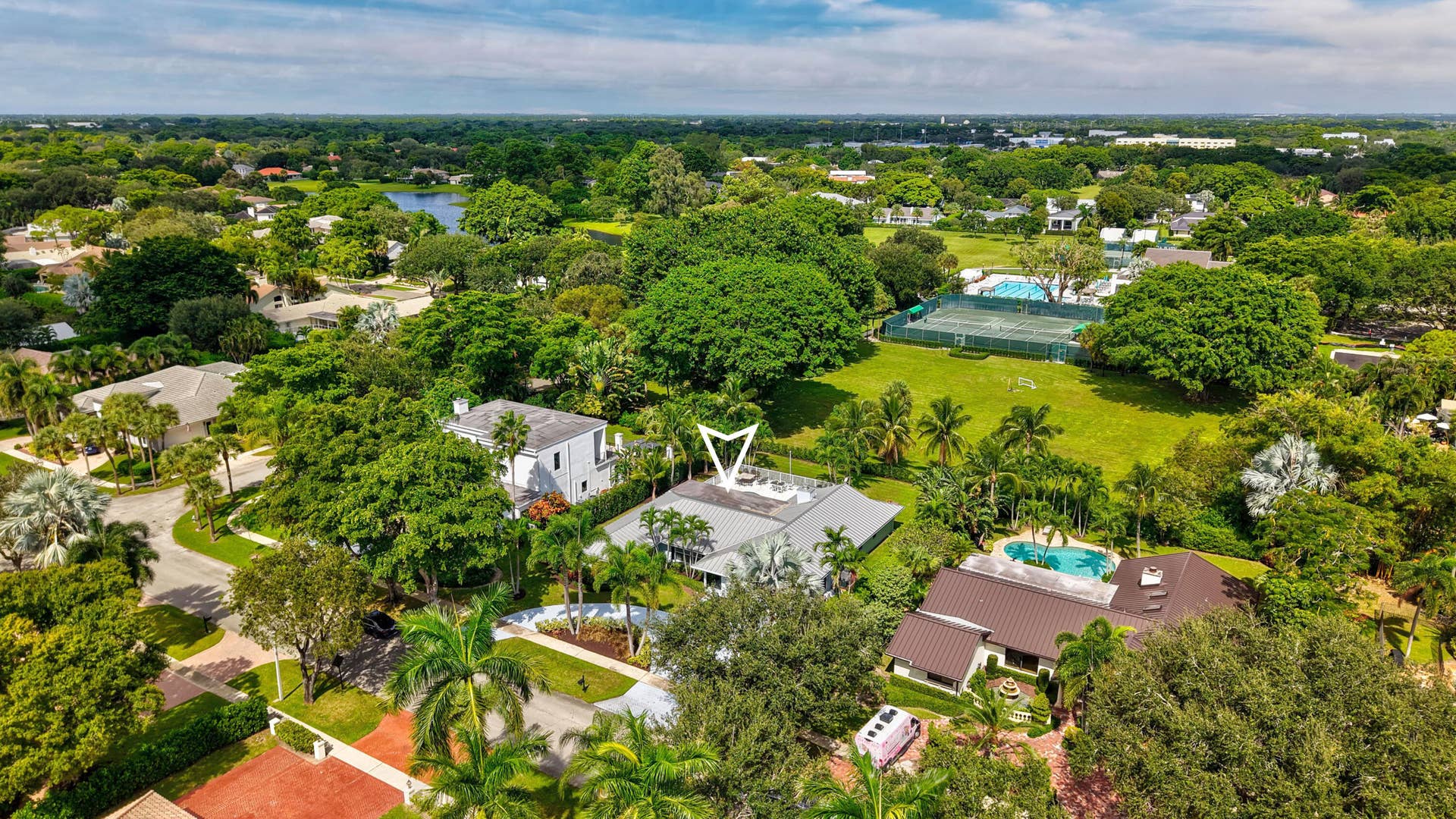 2919 Banyan Blvd Circle NW, Boca Raton, FL 33431 Aerial perspective featuring a residential lot with mature trees, landscaped grounds, and a private swimming pool