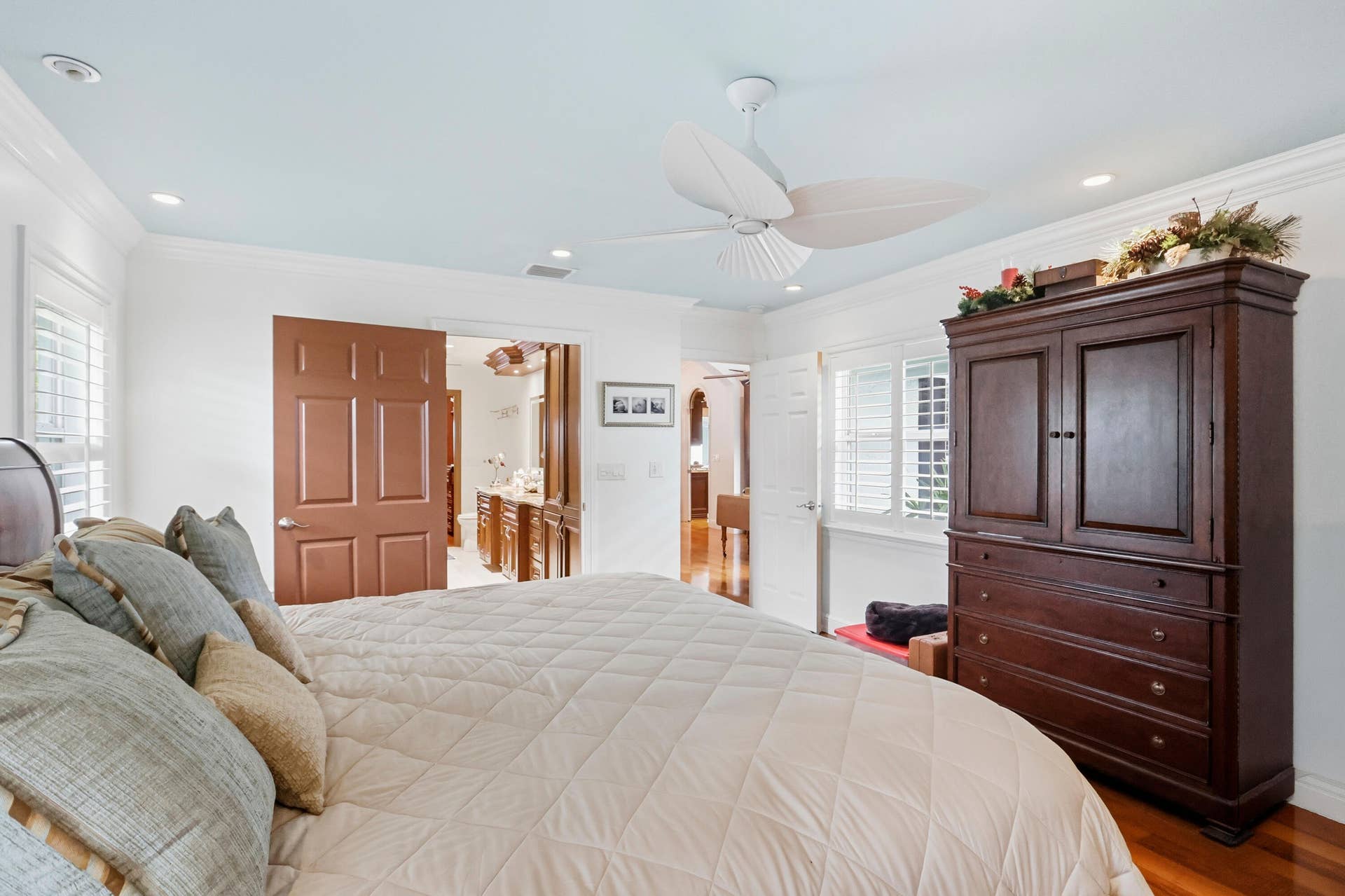 2919 Banyan Blvd Circle NW, Boca Raton, FL 33431 Room featuring light blue ceiling, recessed lighting, white louvered shutters, crown molding, and a three-blade ceiling fan