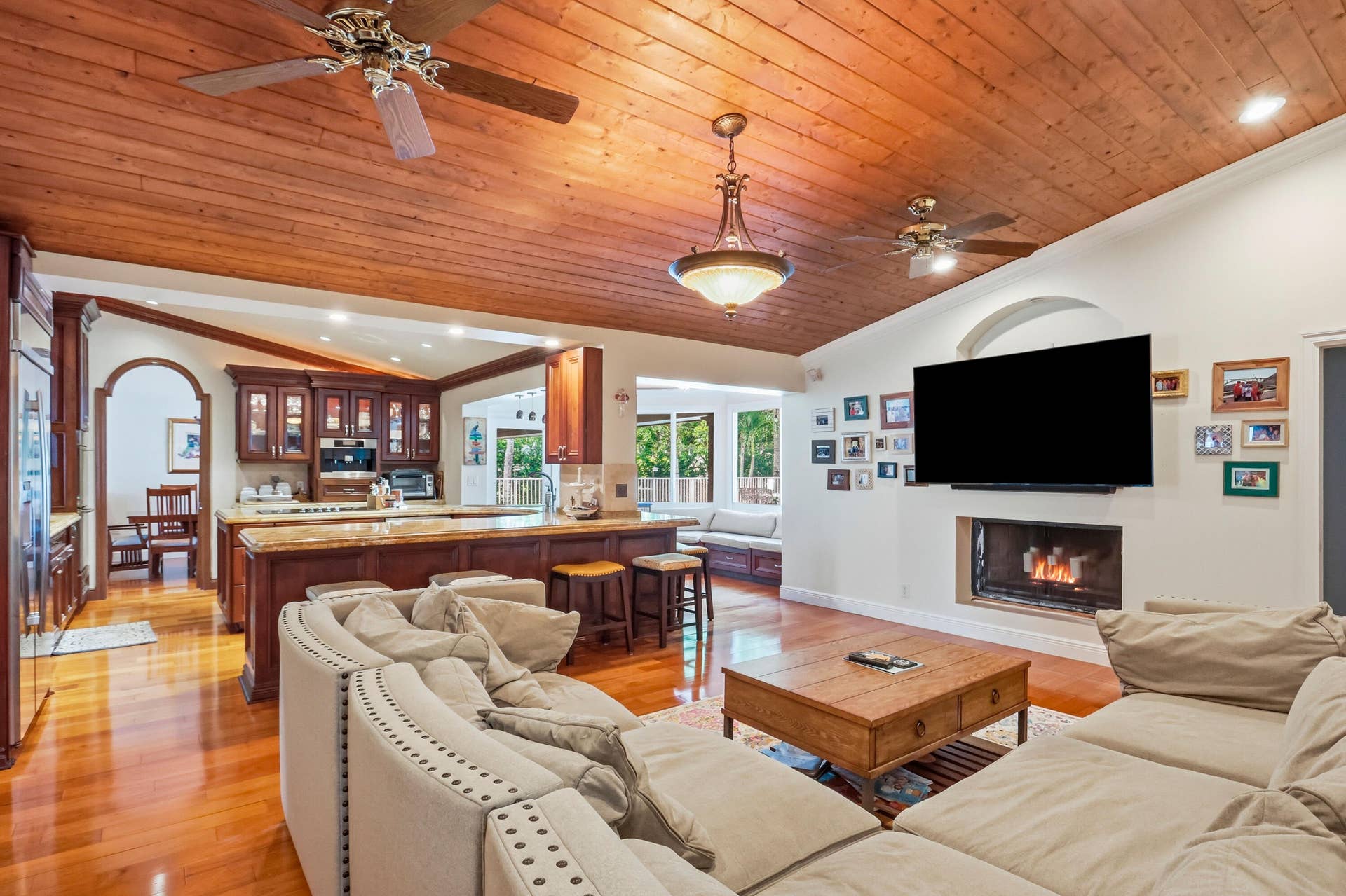 2919 Banyan Blvd Circle NW, Boca Raton, FL 33431 Vaulted ceiling with wood-plank finish, integrated ceiling fans, recessed lighting, and central pendant fixture