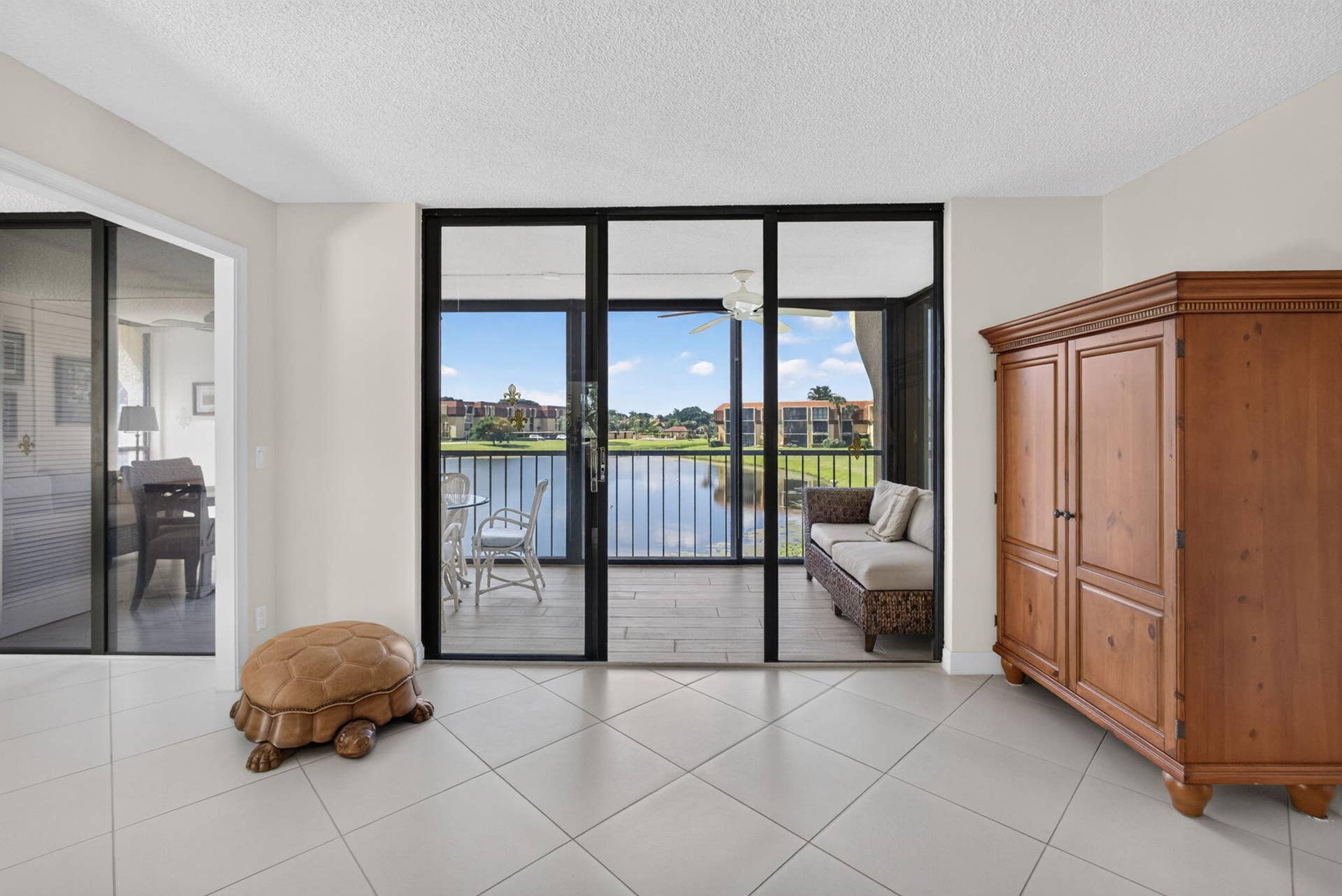 5344 WOODLAND LAKES Drive, #225, Palm Beach Gardens, FL 33418 Living Room to Balcony