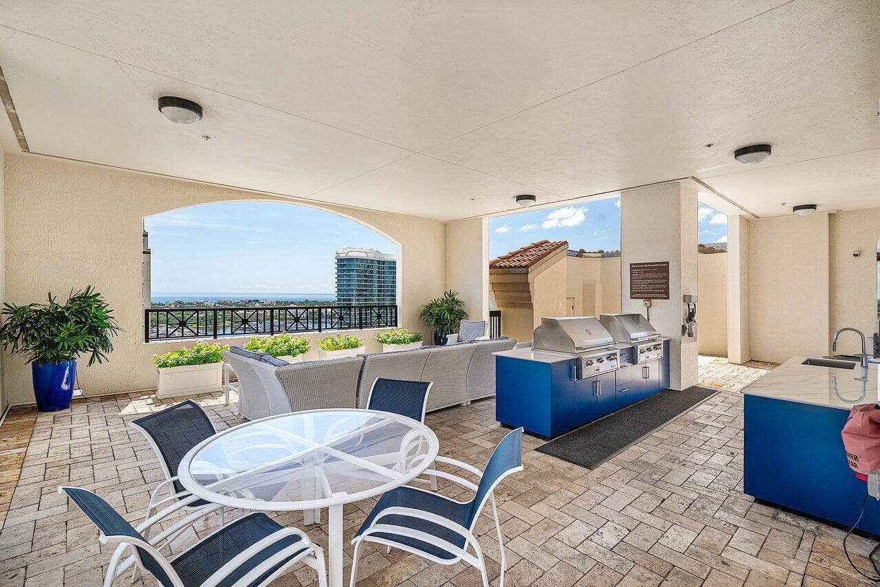 pool deck sitting next to gas grilling