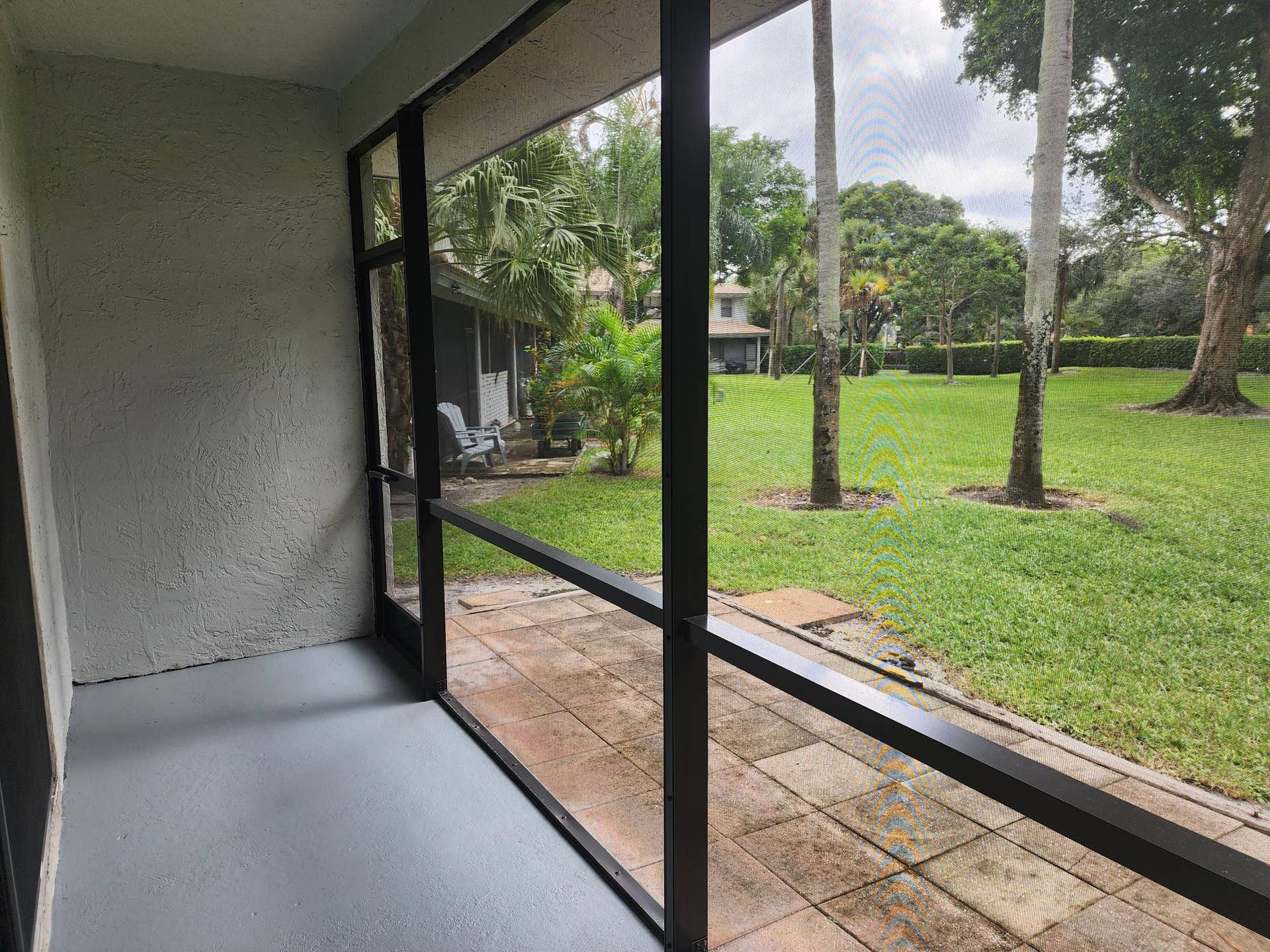 9885 Riverside Drive, Coral Springs, FL 33071 Back porch screen entrance with garden view