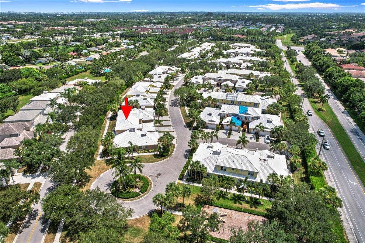 Aerial view highlighting the townhome's setting and nearby residential streets.