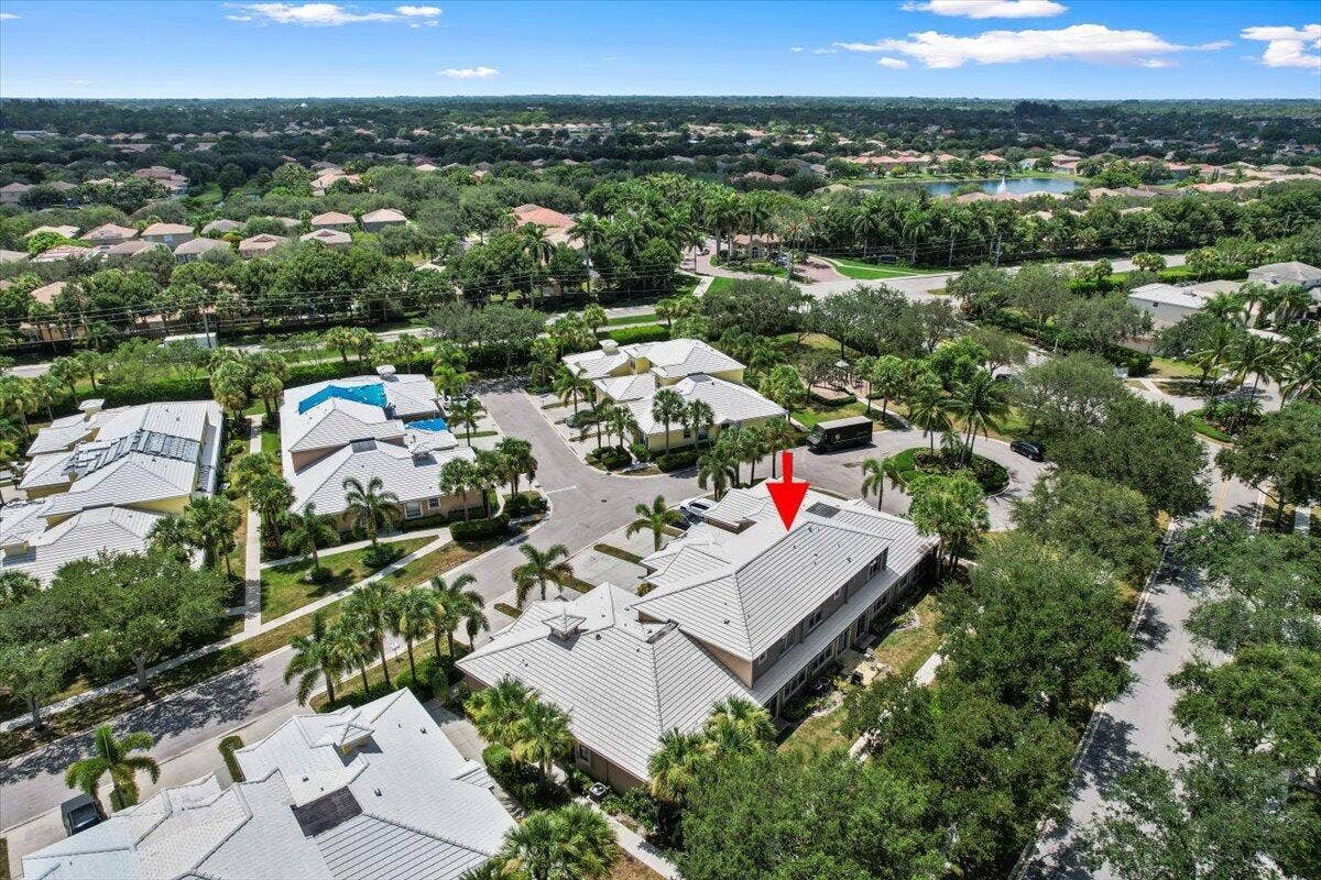 Aerial perspective of the property highlighting the roof and surrounding landscaping.