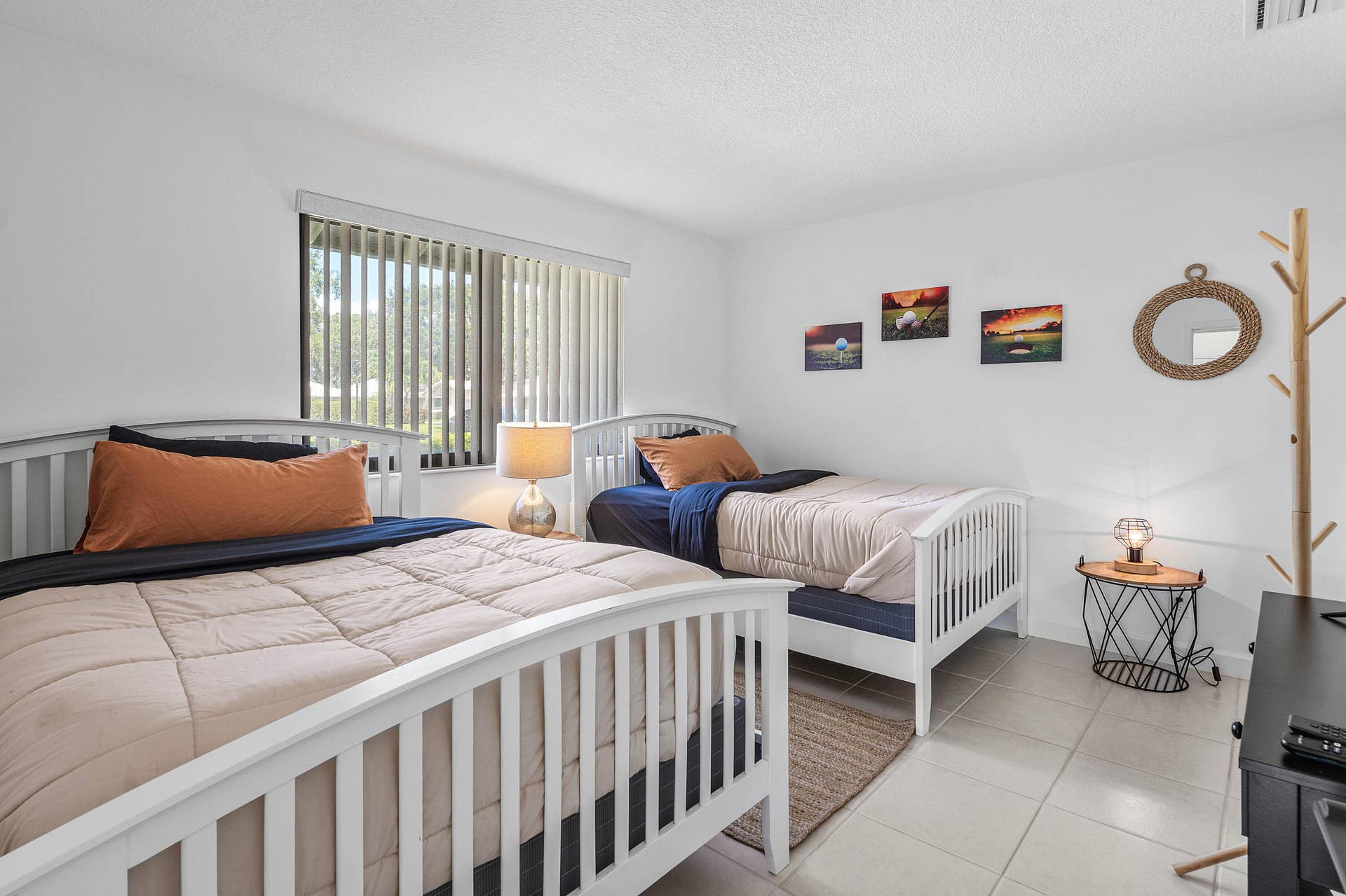 526 Club Drive, Palm Beach Gardens, FL 33418 Bedroom featuring light-colored tile flooring, neutral wall tones, and a window fitted with vertical blinds