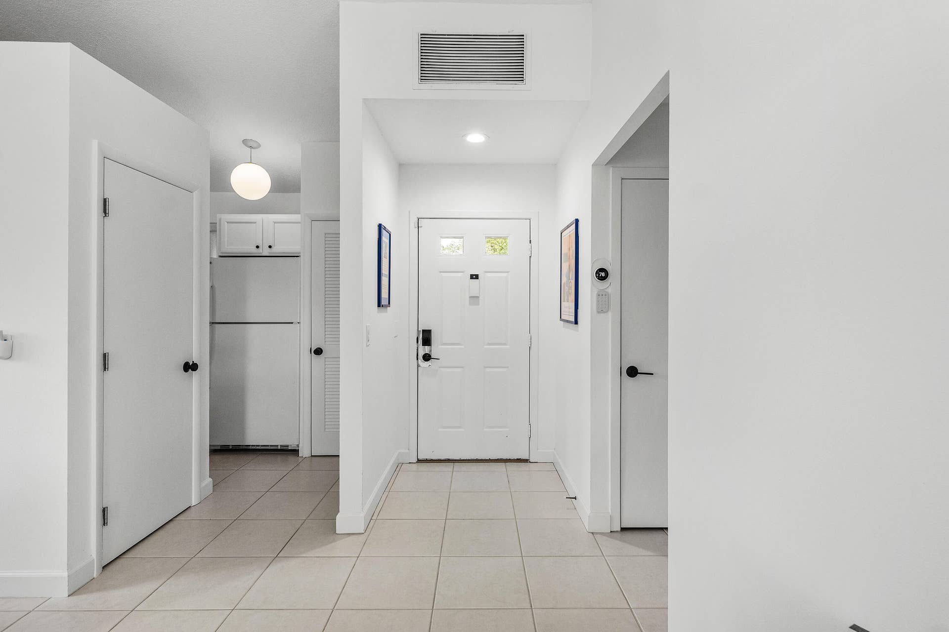 526 Club Drive, Palm Beach Gardens, FL 33418 Entryway featuring neutral tile flooring, a six-panel front door with dual glass inserts, and recessed ceiling lighting