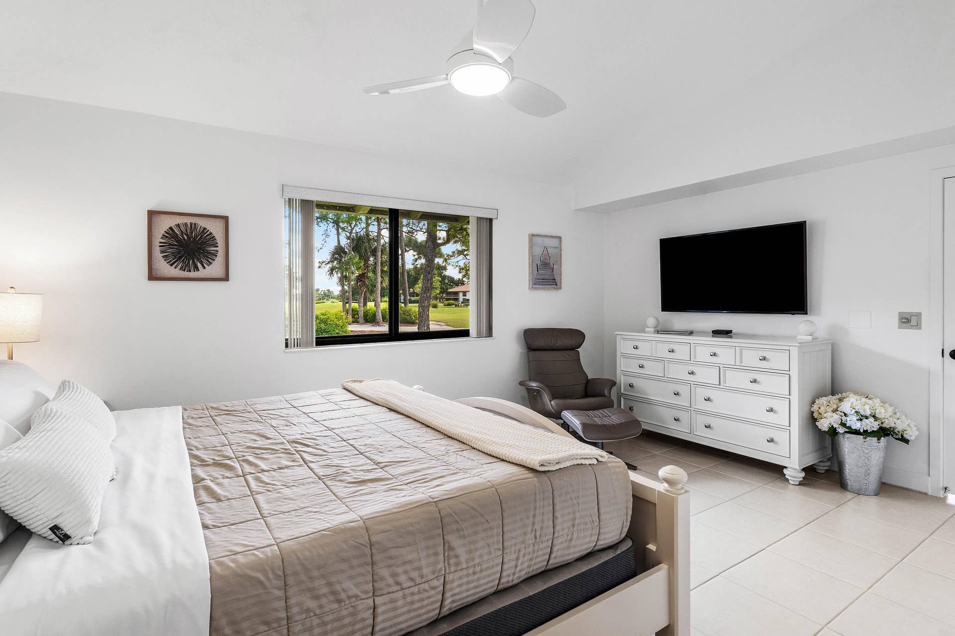 526 Club Drive, Palm Beach Gardens, FL 33418 Neutral wall tones, oversized tile flooring, recessed window casing, and a multi-blade ceiling fan with integrated lighting