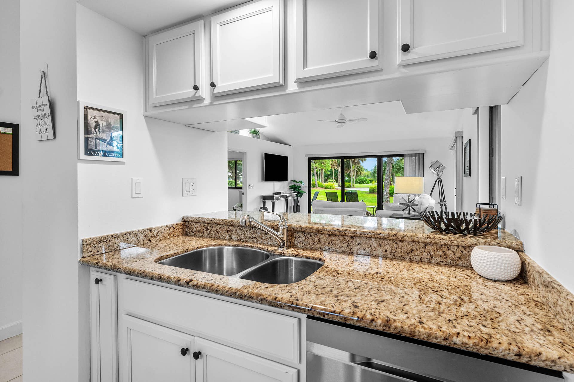 526 Club Drive, Palm Beach Gardens, FL 33418 Kitchen featuring white cabinetry, stone-surface countertops, dual-basin stainless steel sink, and stainless steel dishwasher