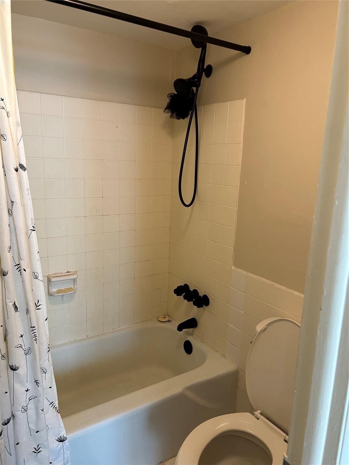 305 N POMPANO BEACH Boulevard, #206, Pompano Beach, Pompano Beach, FL 33062 Bathtub and shower combination featuring square wall tiling, matte black fixtures, and an integrated soap dish