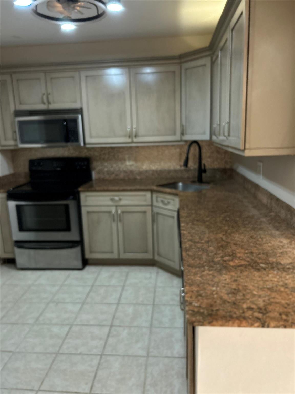 305 N POMPANO BEACH Boulevard, #206, Pompano Beach, Pompano Beach, FL 33062 Kitchen featuring Shaker-style cabinetry, stone-finish countertops, stainless steel appliances, a high-arc faucet, and tiled flooring
