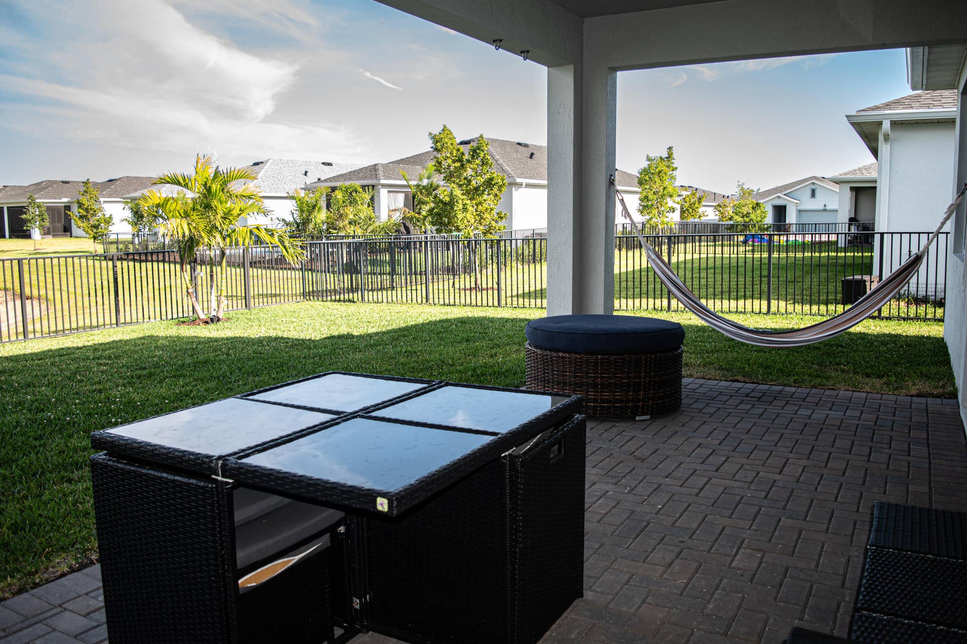 10317 SW Phineas Lane, Port St Lucie, FL 34987 Covered patio featuring a paver surface, fenced backyard, and lawn area