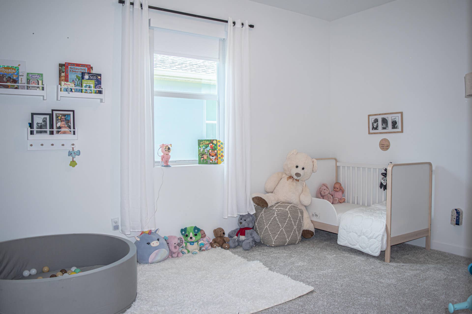 10317 SW Phineas Lane, Port St Lucie, FL 34987 Neutral-toned wall-to-wall carpeting, window with central sill, and wall-mounted shelving units