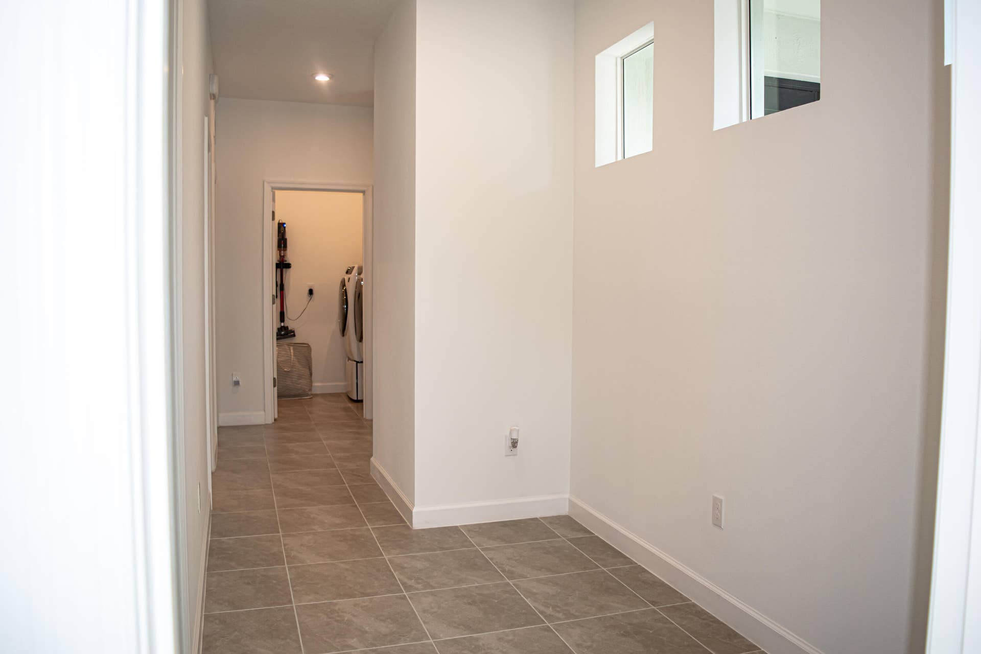 10317 SW Phineas Lane, Port St Lucie, FL 34987 Neutral-toned ceramic tile flooring, high-placed square windows, and recessed lighting