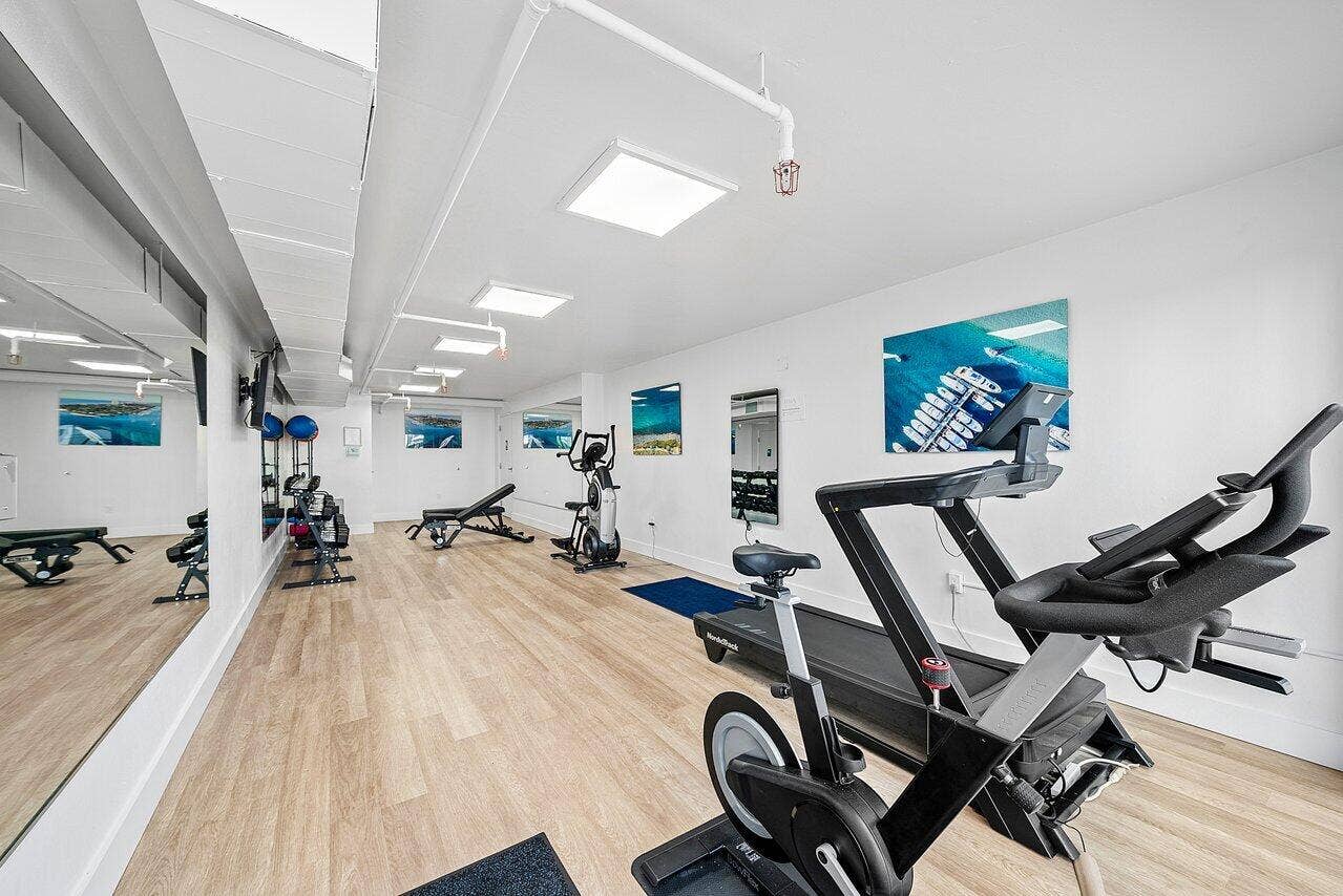 184 Lake Drive, #4201, Palm Beach Shores, FL 33404 Spacious interior featuring wood-finish flooring, recessed lighting, and expansive wall-mounted mirrors