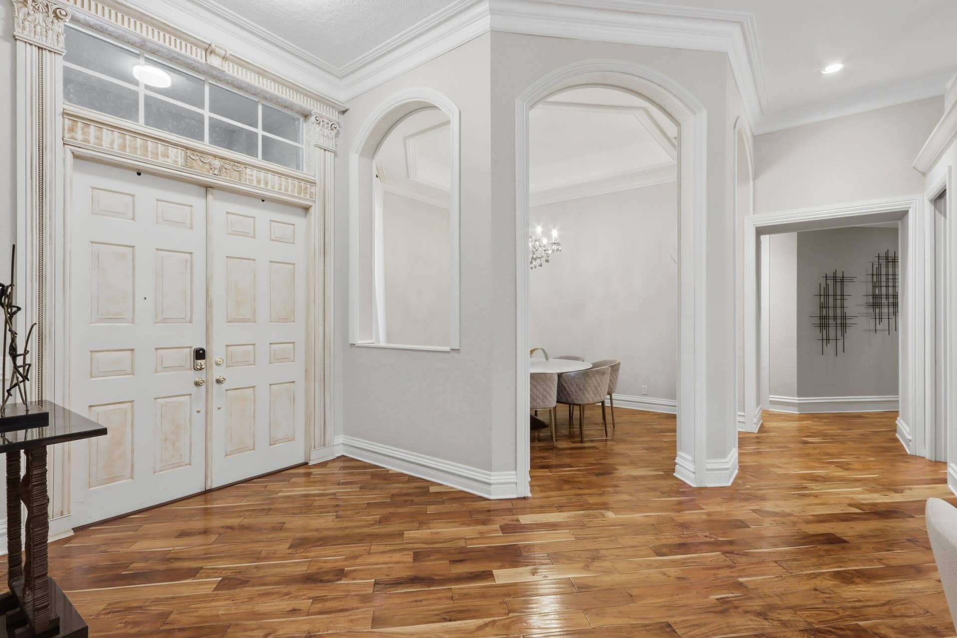 1580 VICTORIA ISLE Way, Weston, FL 33327 Foyer featuring wood-finish flooring, double entry doors with transom window, arched architectural openings, and extensive crown molding