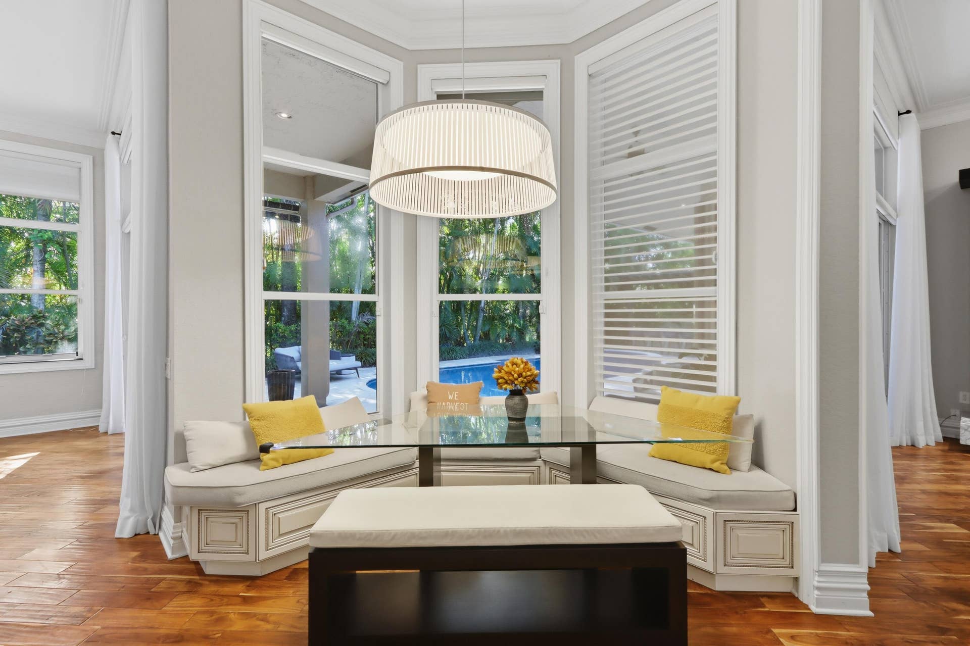 1580 VICTORIA ISLE Way, Weston, FL 33327 Bay window featuring built-in bench seating, wood-finish flooring, floor-to-ceiling windows, and a drum-style pendant light fixture