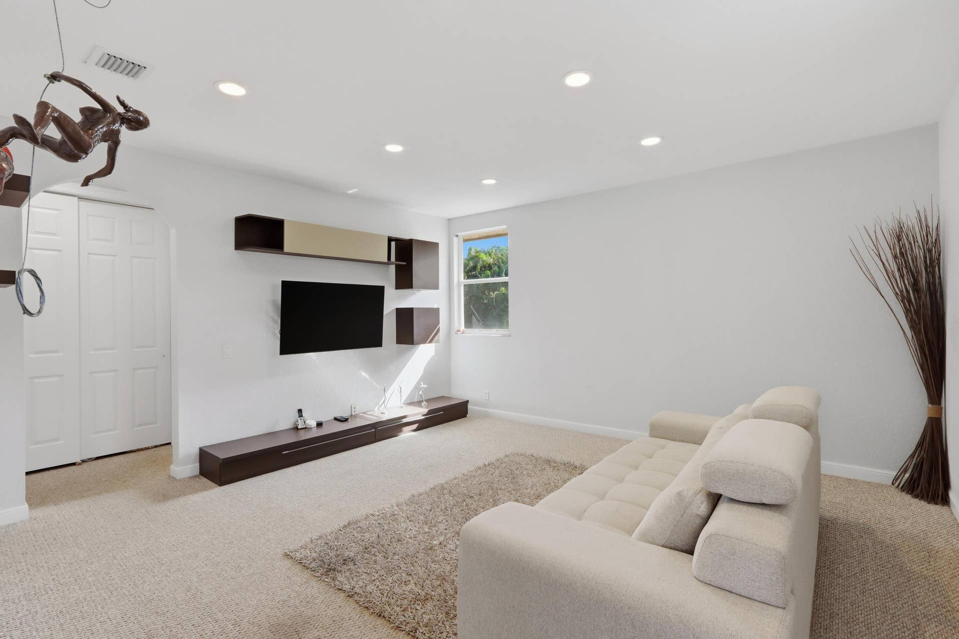 1580 VICTORIA ISLE Way, Weston, FL 33327 Recessed ceiling lighting, wall-mounted cabinetry, custom media shelving, and dual-panel closet doors