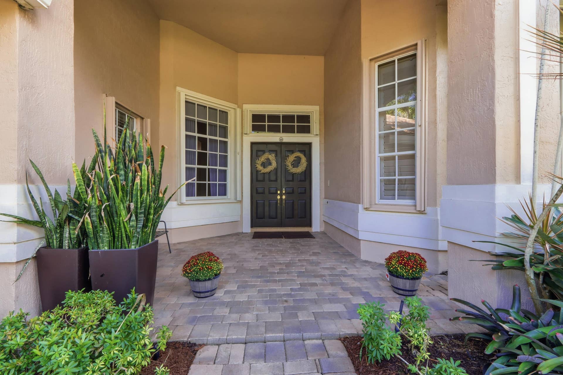 1580 VICTORIA ISLE Way, Weston, FL 33327 Covered entryway featuring a paver stone porch, double front doors, and a transom window