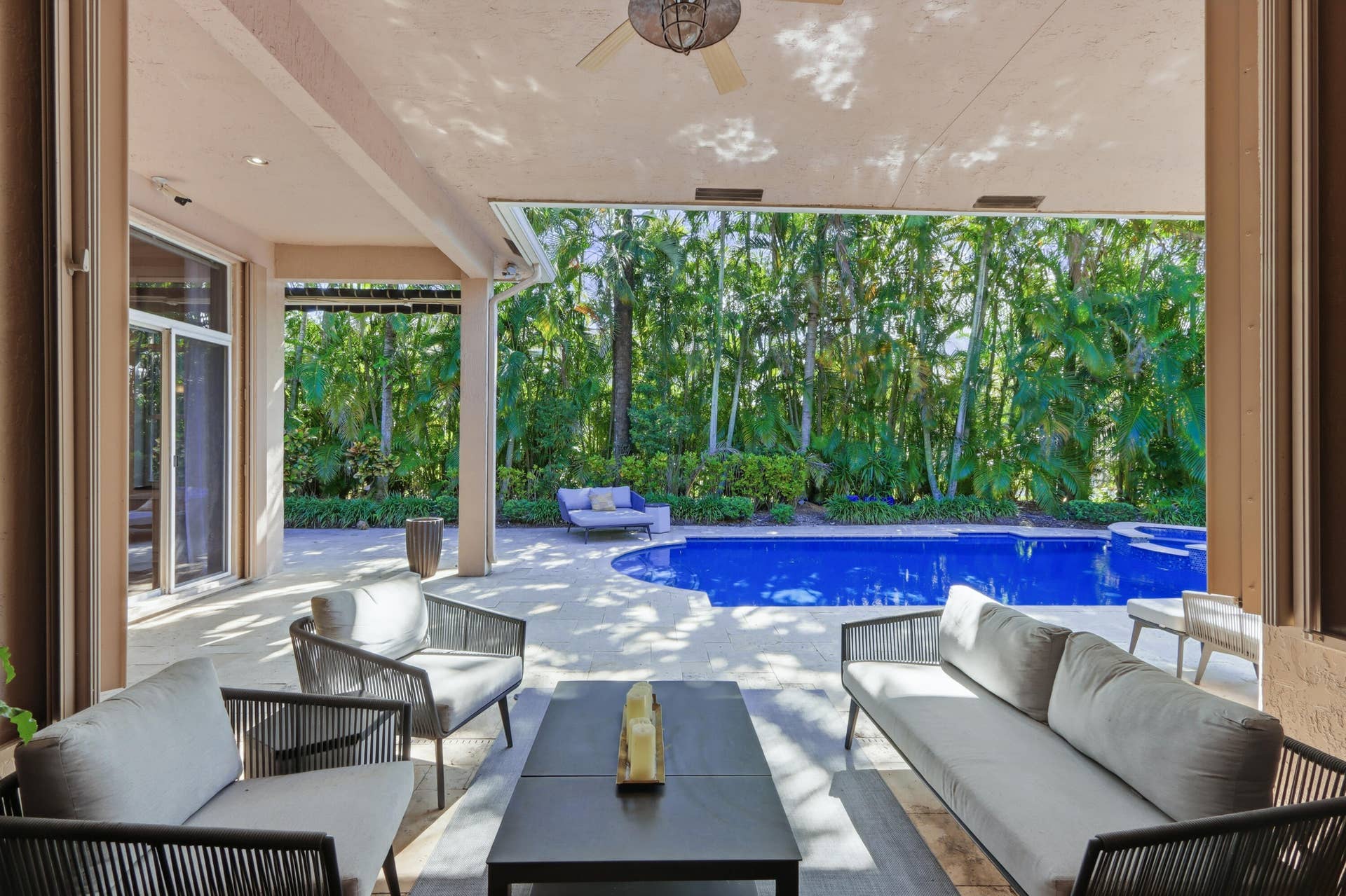 1580 VICTORIA ISLE Way, Weston, FL 33327 Covered patio featuring a ceiling fan, stone-style hardscaping, recessed lighting, and a pool with an integrated spa