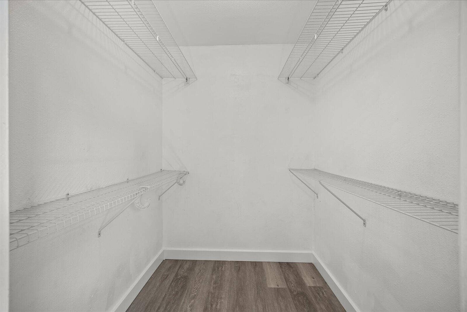 113 CONOVER Avenue, Sebastian, FL 32958 Walk-in closet featuring dual-level white wire shelving and wood-finish flooring