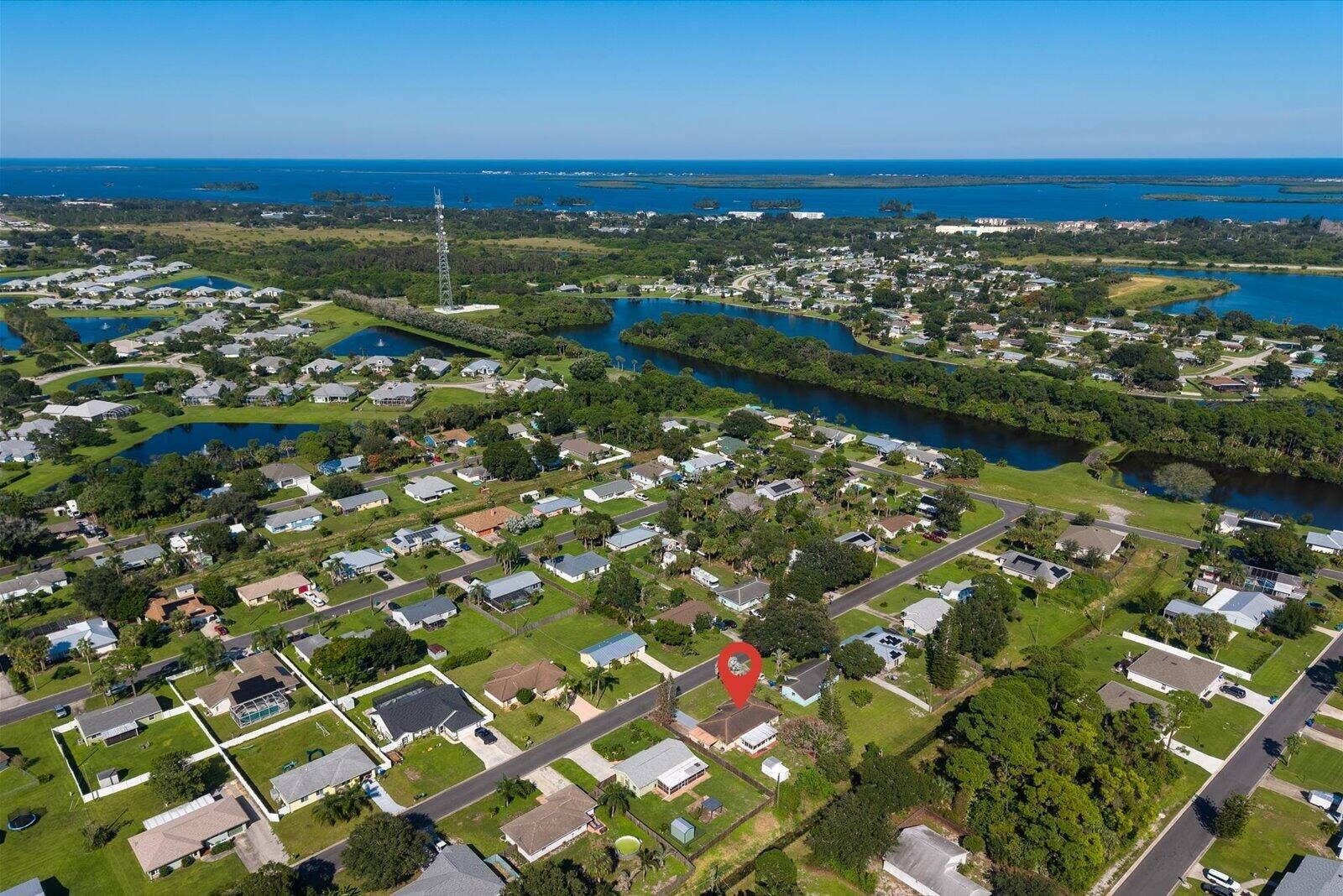 113 CONOVER Avenue, Sebastian, FL 32958 Aerial perspective showcasing a residential lot situated within a waterfront community featuring canal access and mature greenery