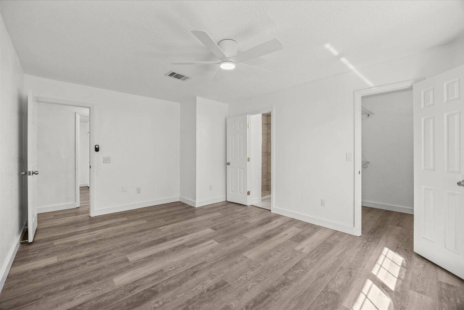 113 CONOVER Avenue, Sebastian, FL 32958 Wood-finish flooring, white walls, and a ceiling fan with integrated lighting