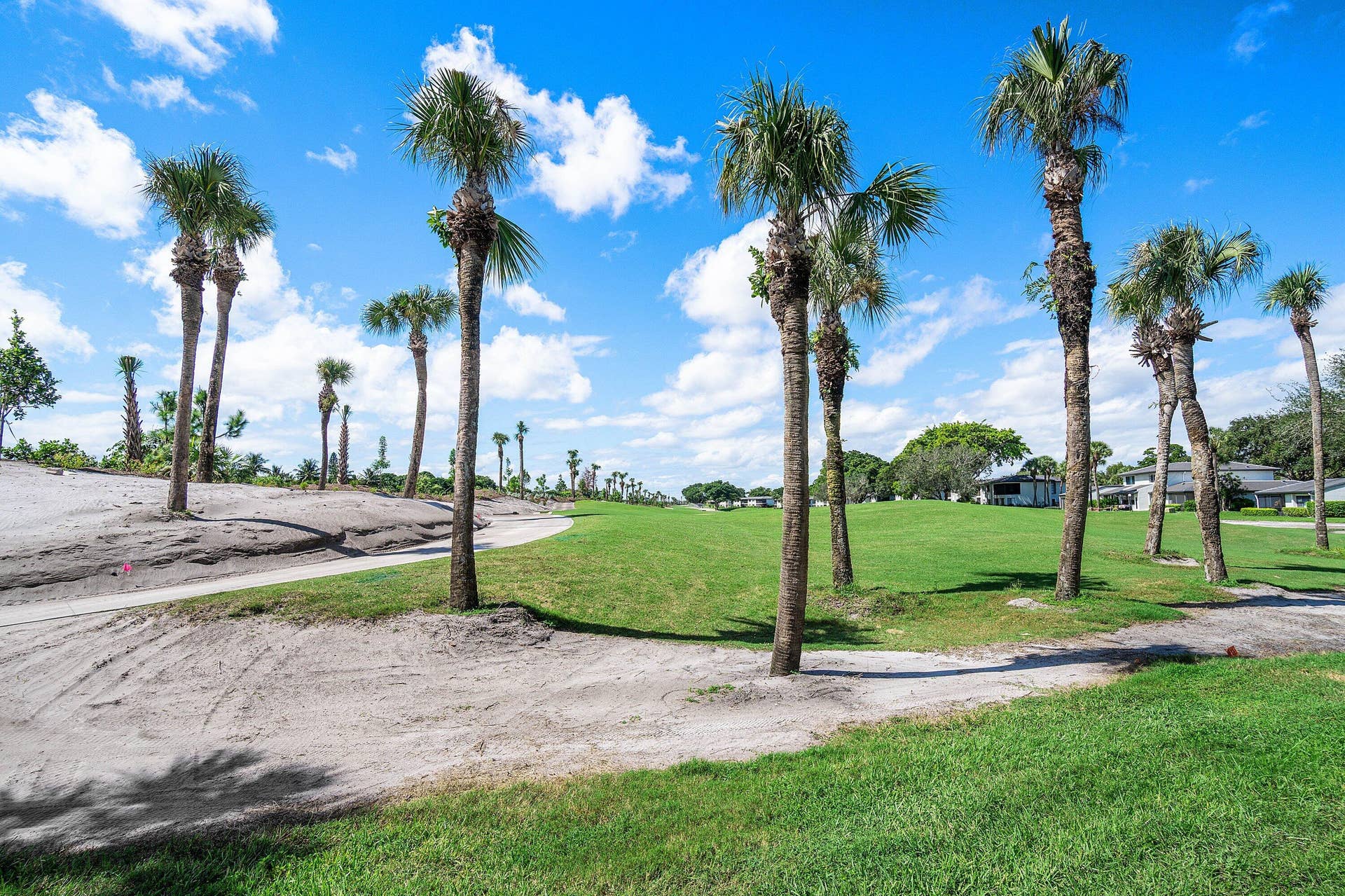 21 Southport Lane, #B, Boynton Beach, FL 33436 Extensive grounds featuring manicured turf, mature palm trees, and sand bunker elements