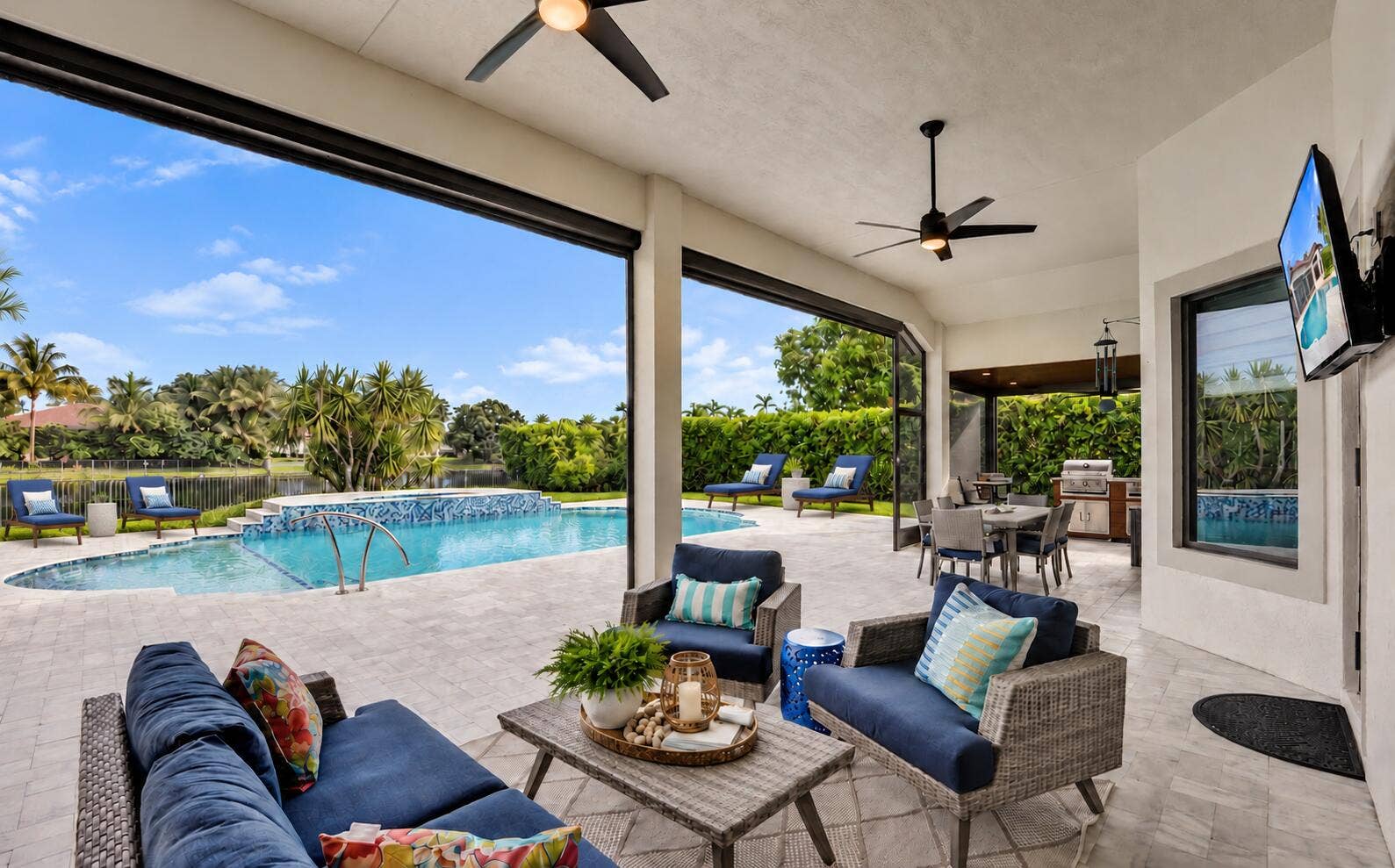 Covered patio with motarized screens for unobstructed views and no mosquitos...