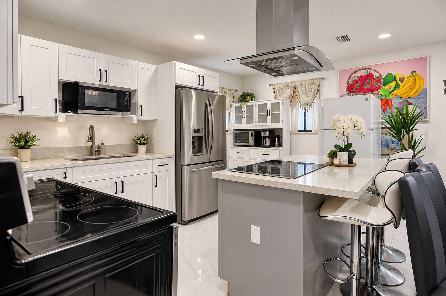 1946 NW 152nd Terrace, Miami Gardens, FL 33054 Kitchen featuring white shaker-style cabinetry, a central island with a stone-finish countertop, stainless steel appliances, a glass-panel overhead range hood, and tile flooring