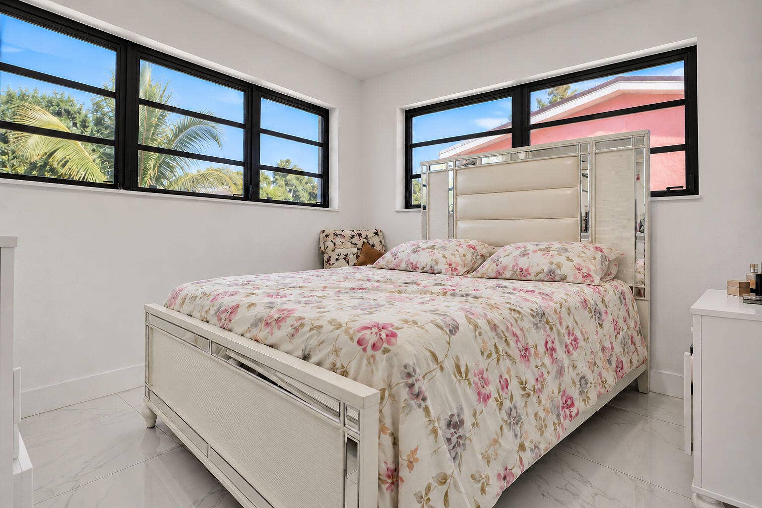 1946 NW 152nd Terrace, Miami Gardens, FL 33054 Bright interior space featuring light-toned tile flooring, neutral walls, and large horizontal windows with black frames