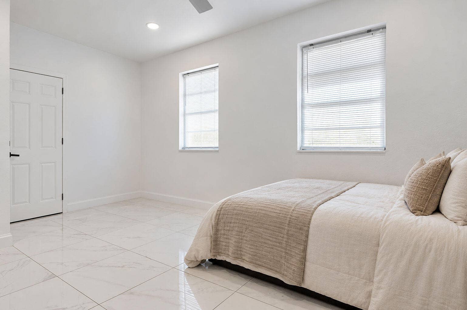 1946 NW 152nd Terrace, Miami Gardens, FL 33054 Large-format tile flooring, recessed ceiling lighting, and dual windows with horizontal blinds