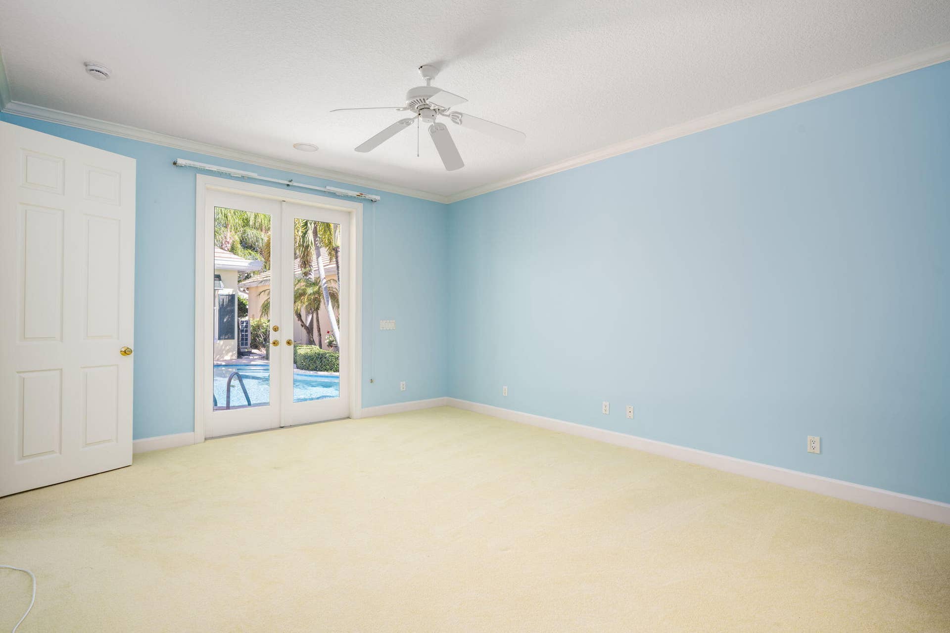 Master with custom closets and French doors to courtyard