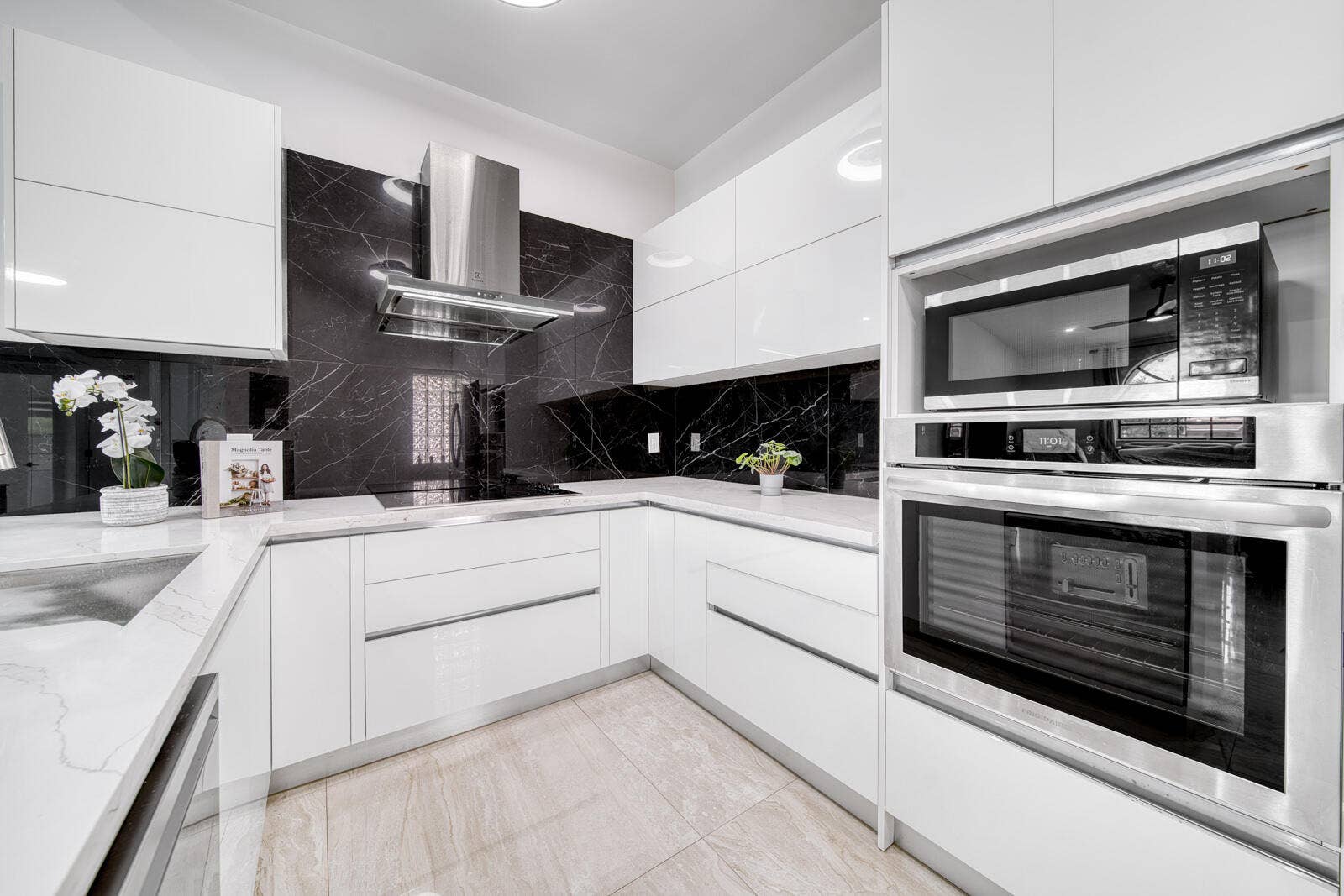 10690 NW 14TH Street, #138, Plantation, FL 33322 High-end stainless steel appliances include a built-in oven, cooktop, and microwave.