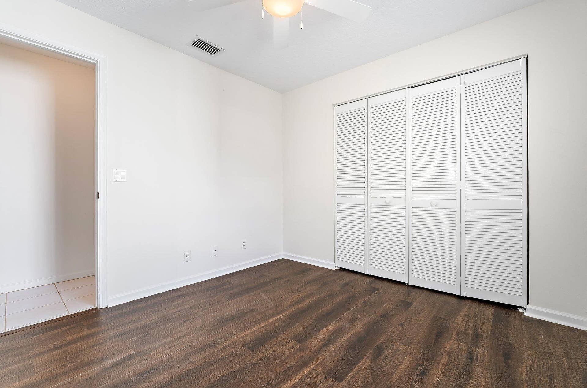 6037 Foster Street, Jupiter, FL 33458 Guest bedroom with a double closet and natural light.