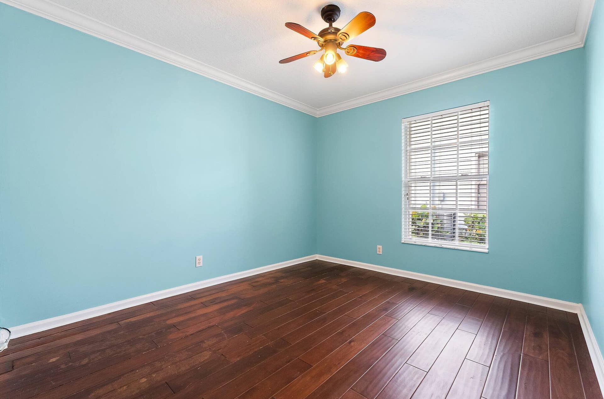 6037 Foster Street, Jupiter, FL 33458 Guest bedroom with wood floors and a ceiling fan.